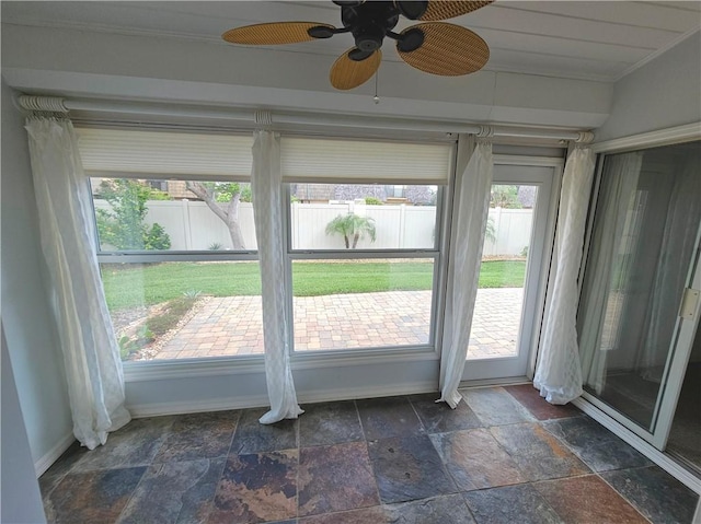 542 9th Pl, Vero Beach, FL 32960 - unfurnished sunroom featuring stone tile flooring and ornamental molding