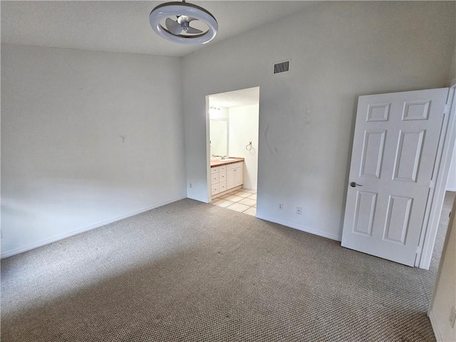 542 9th Pl, Vero Beach, FL 32960 - unfurnished bedroom featuring light colored carpet and connected bathroom