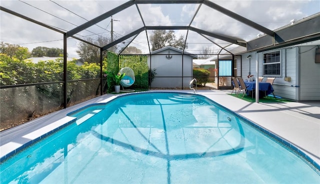 view of pool with a patio, a jacuzzi, and a lanai