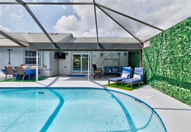 view of pool with an outdoor hangout area, a patio area, and a lanai