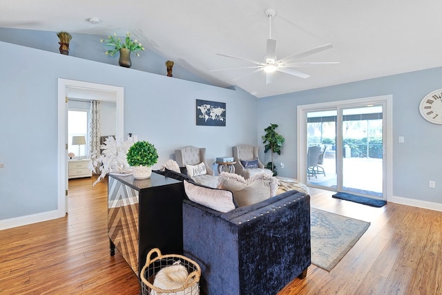 living room with lofted ceiling, ceiling fan, and light hardwood / wood-style flooring