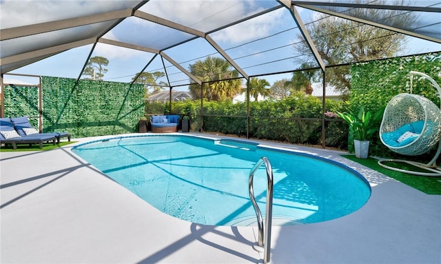 view of pool with a patio and glass enclosure