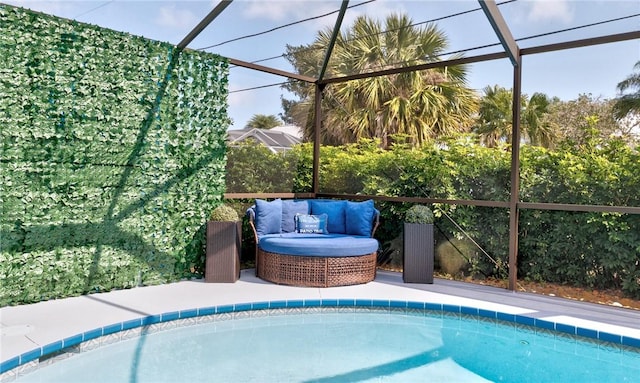 view of swimming pool featuring an outdoor hangout area and glass enclosure