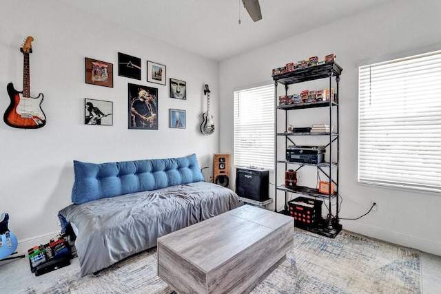 bedroom with a ceiling fan and baseboards