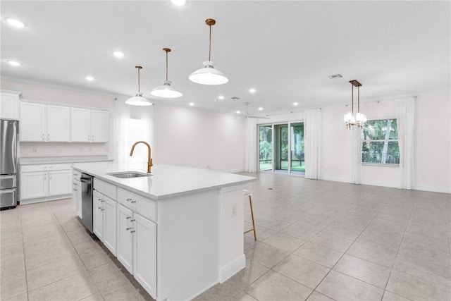 kitchen with a sink, light tile patterned floors, stainless steel appliances, and open floor plan