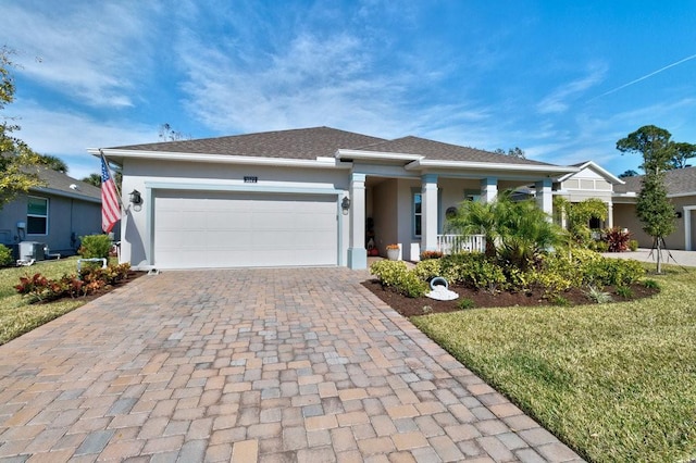 view of front of property featuring central AC unit, covered porch, stucco siding, a garage, and decorative driveway