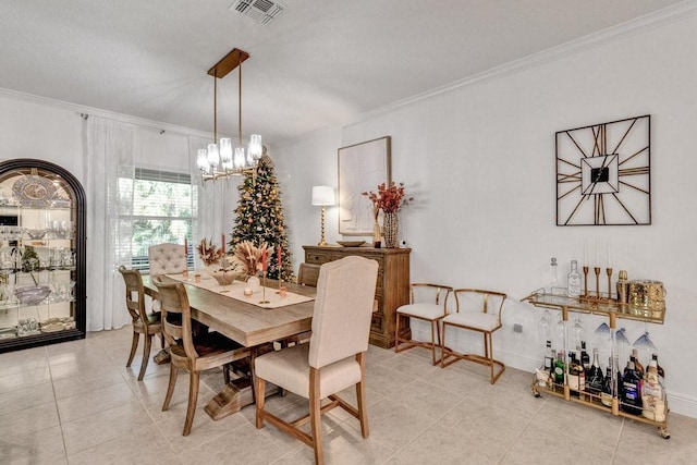 dining area with light tile patterned floors, visible vents, crown molding, and an inviting chandelier