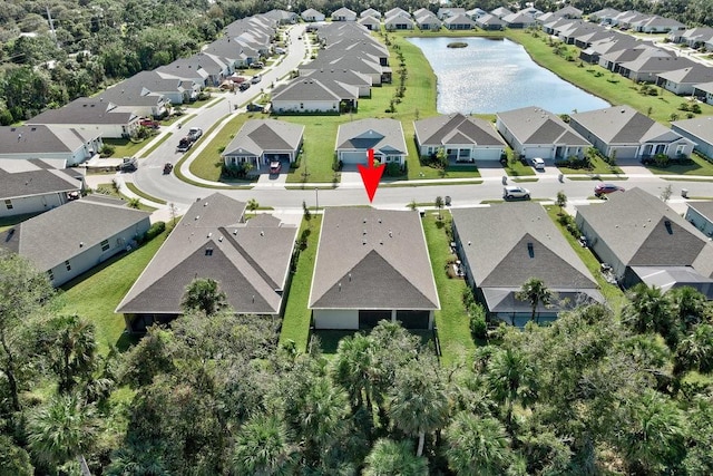 birds eye view of property featuring a residential view and a water view