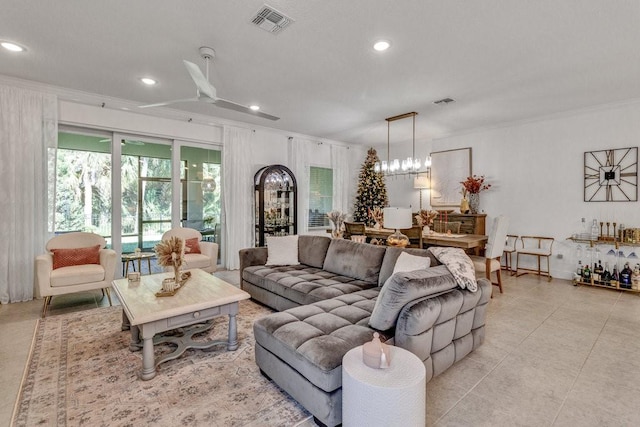 living room featuring visible vents, light tile patterned flooring, recessed lighting, ornamental molding, and a notable chandelier