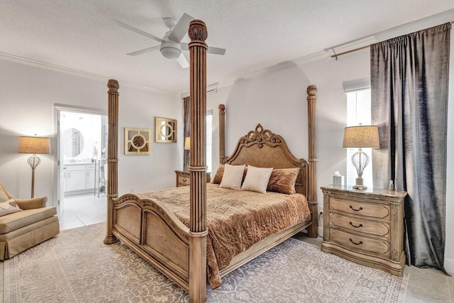 bedroom with ornamental molding, a textured ceiling, and decorative columns