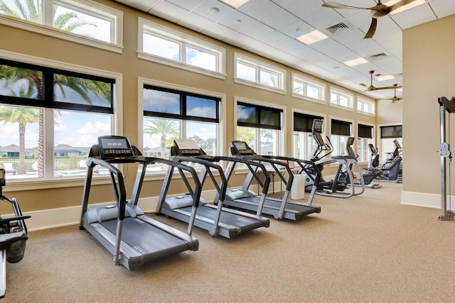 exercise room featuring visible vents, carpet floors, and a healthy amount of sunlight