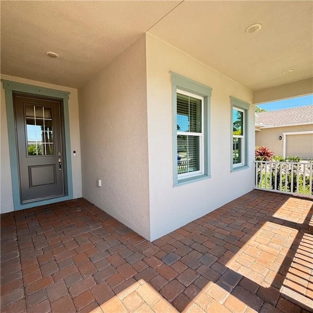 view of exterior entry with stucco siding