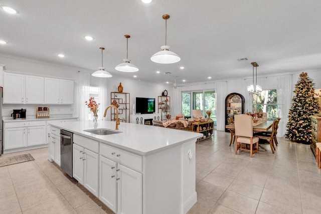 kitchen with dishwasher, an island with sink, light countertops, light tile patterned floors, and a sink