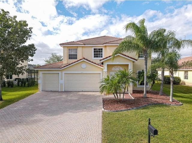 mediterranean / spanish-style house featuring a garage and a front lawn