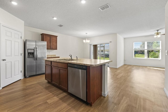 kitchen with dark hardwood / wood-style flooring, a wealth of natural light, sink, and stainless steel appliances