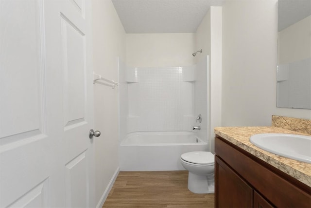 full bathroom with shower / bathing tub combination, hardwood / wood-style floors, vanity, and toilet