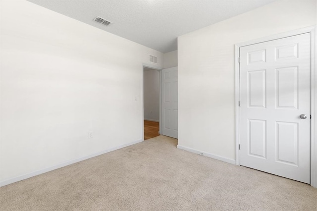 unfurnished bedroom with light colored carpet