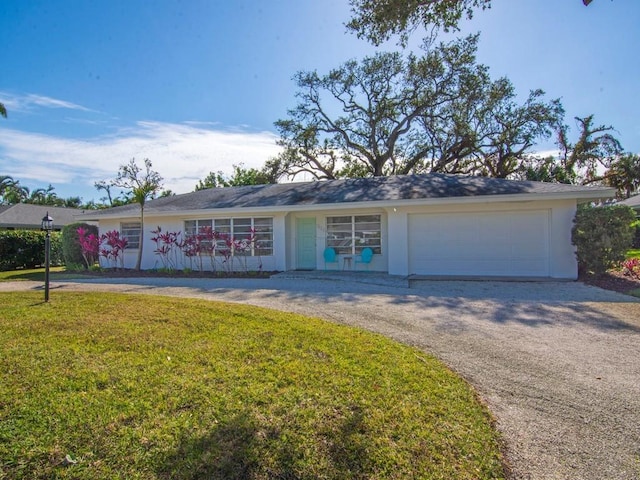 ranch-style home with a front yard and a garage