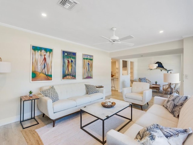 living room with ceiling fan, light hardwood / wood-style flooring, and ornamental molding