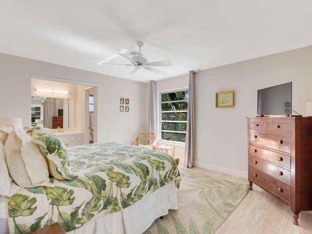 bedroom with ceiling fan, ensuite bathroom, and light hardwood / wood-style flooring