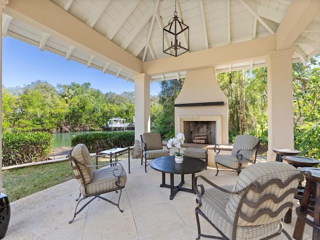 view of patio / terrace with an outdoor fireplace and a gazebo