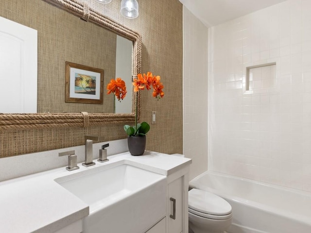 bathroom featuring toilet, wallpapered walls, shower / tub combination, and vanity