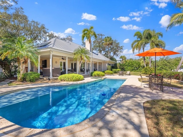 pool with a patio area, ceiling fan, and outdoor lounge area