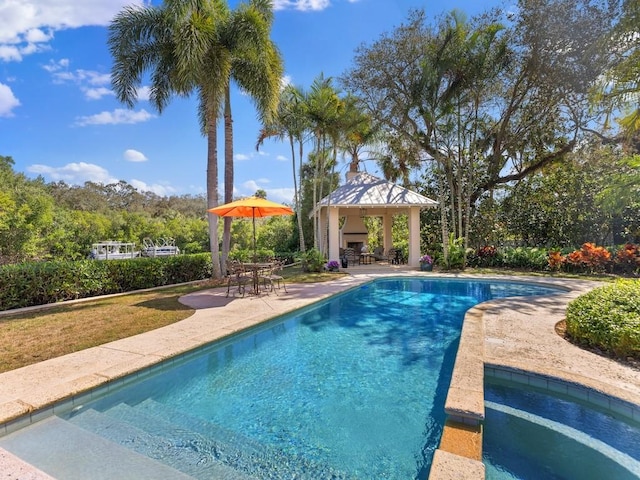 pool featuring a gazebo, a patio area, and an in ground hot tub