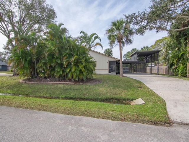 exterior space with a carport and a front yard