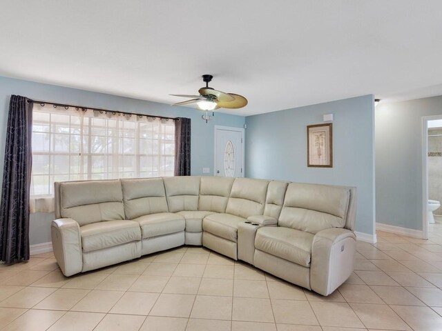 tiled living room featuring ceiling fan