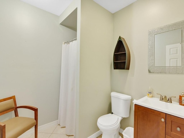 bathroom with vanity, toilet, and tile patterned flooring