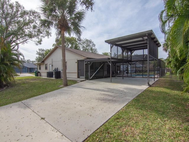 exterior space featuring central AC unit and a lawn