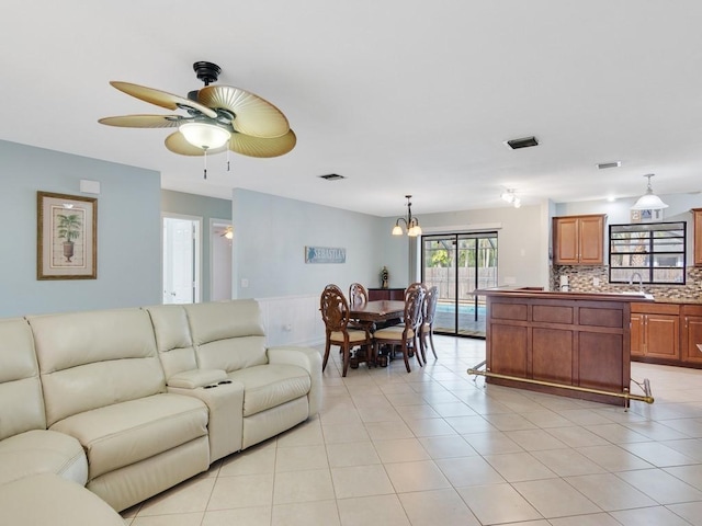 tiled living room with sink and ceiling fan