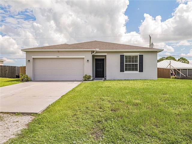 ranch-style house with a garage and a front yard