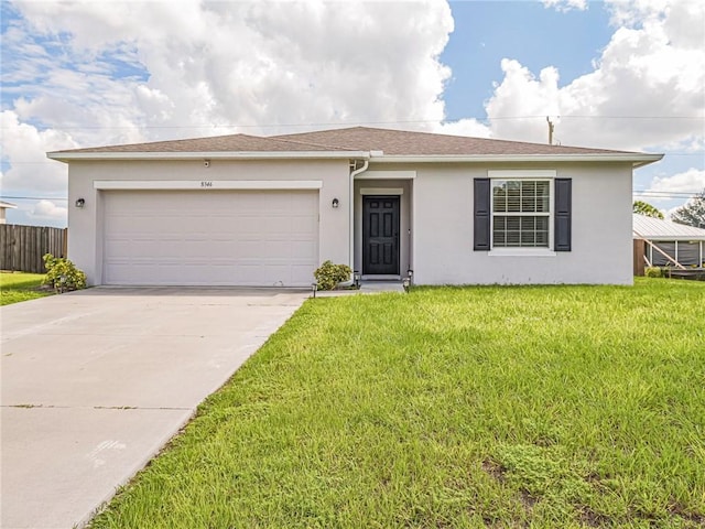 ranch-style home featuring a garage and a front lawn