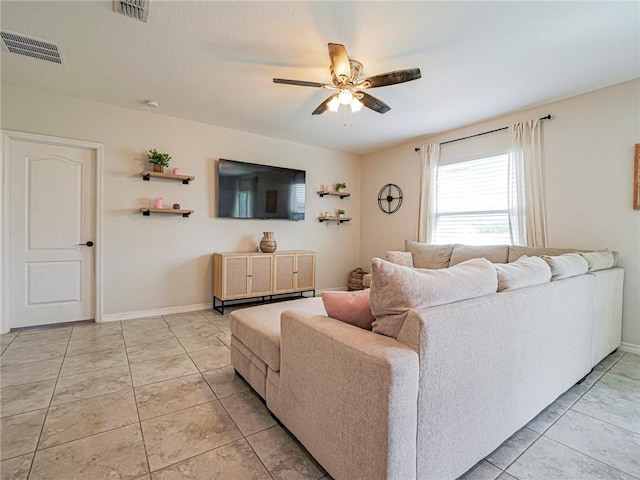 living room featuring light tile patterned floors and ceiling fan