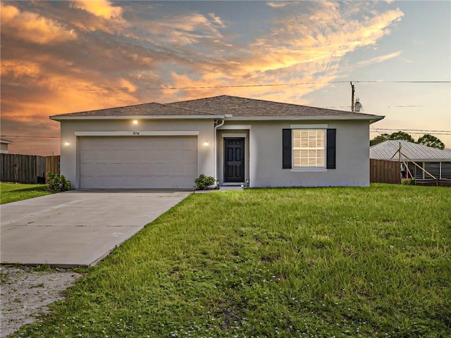 view of front facade featuring a garage and a lawn