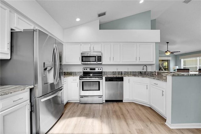 kitchen with sink, white cabinetry, stone counters, and stainless steel appliances