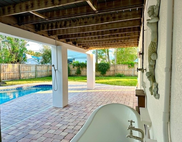 view of patio / terrace with a fenced in pool