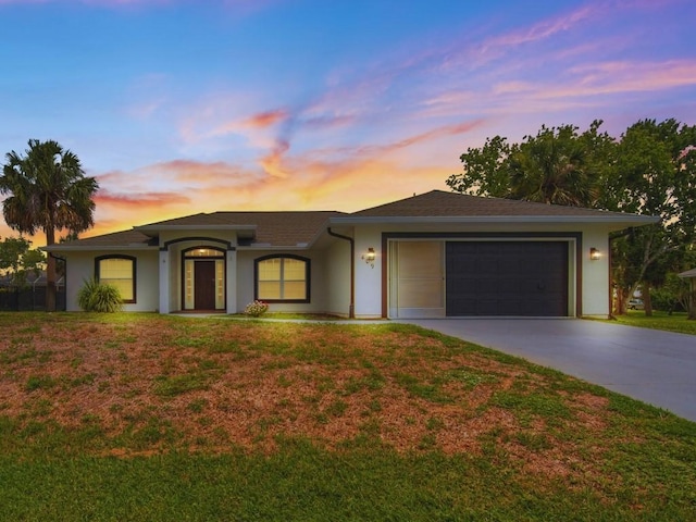409 Bywood Ave, Sebastian, FL 32958 - ranch-style house with driveway, a garage, stucco siding, and a lawn