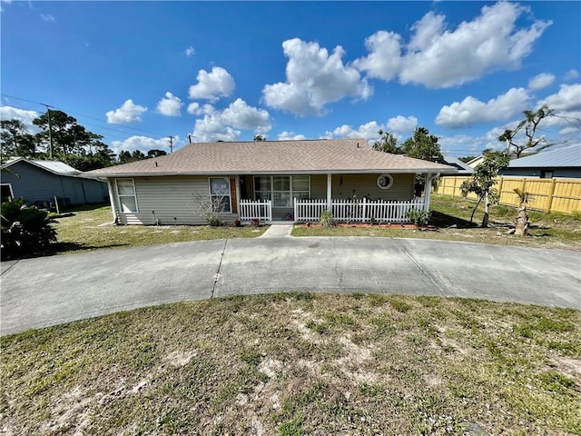 view of front of house with a front yard and covered porch