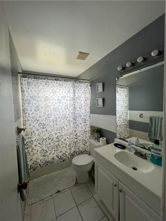 bathroom with vanity, tile patterned flooring, and toilet