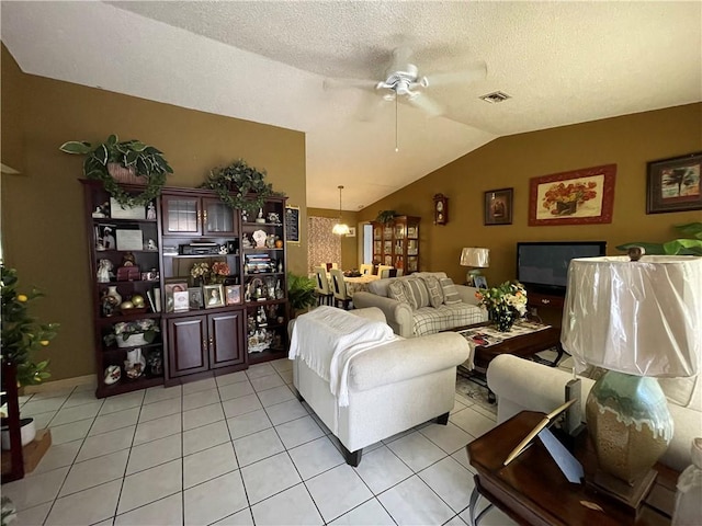 living room with light tile patterned flooring, lofted ceiling, a textured ceiling, and ceiling fan