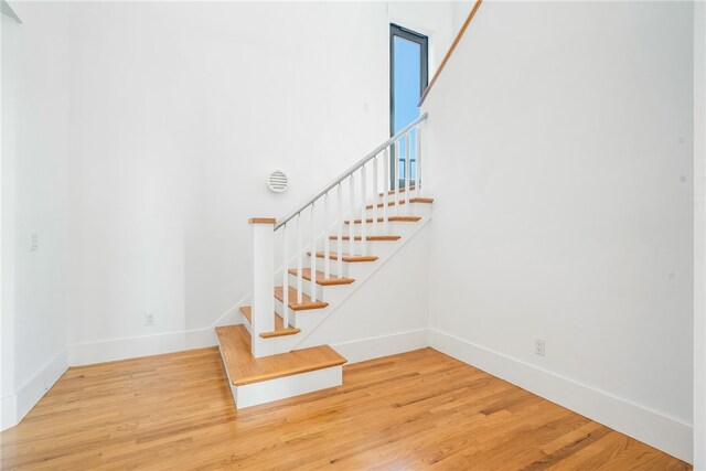 stairs with hardwood / wood-style flooring