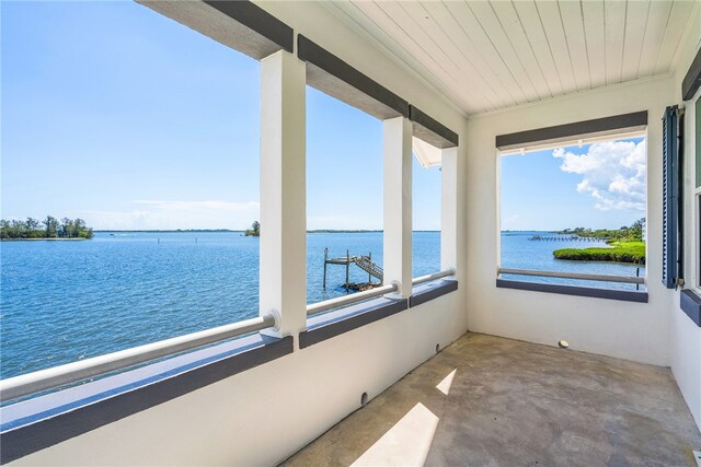 sunroom with a water view and wooden ceiling