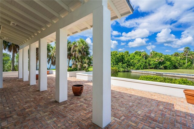 view of patio with a water view