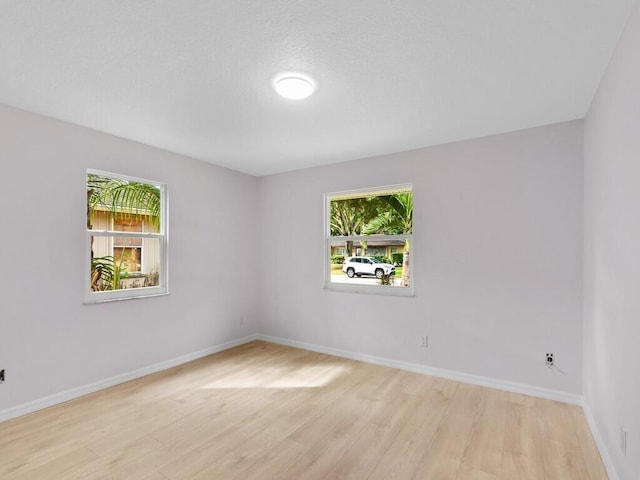 unfurnished room with light hardwood / wood-style floors