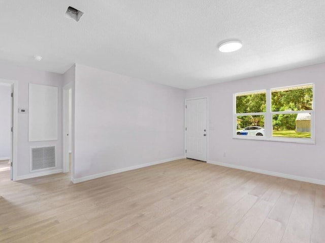 spare room with light hardwood / wood-style flooring