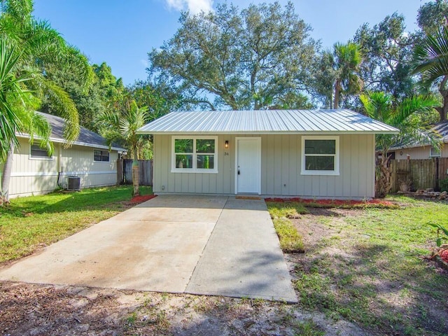 single story home featuring a front yard and central AC