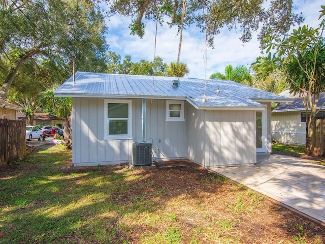 exterior space with central AC and a lawn